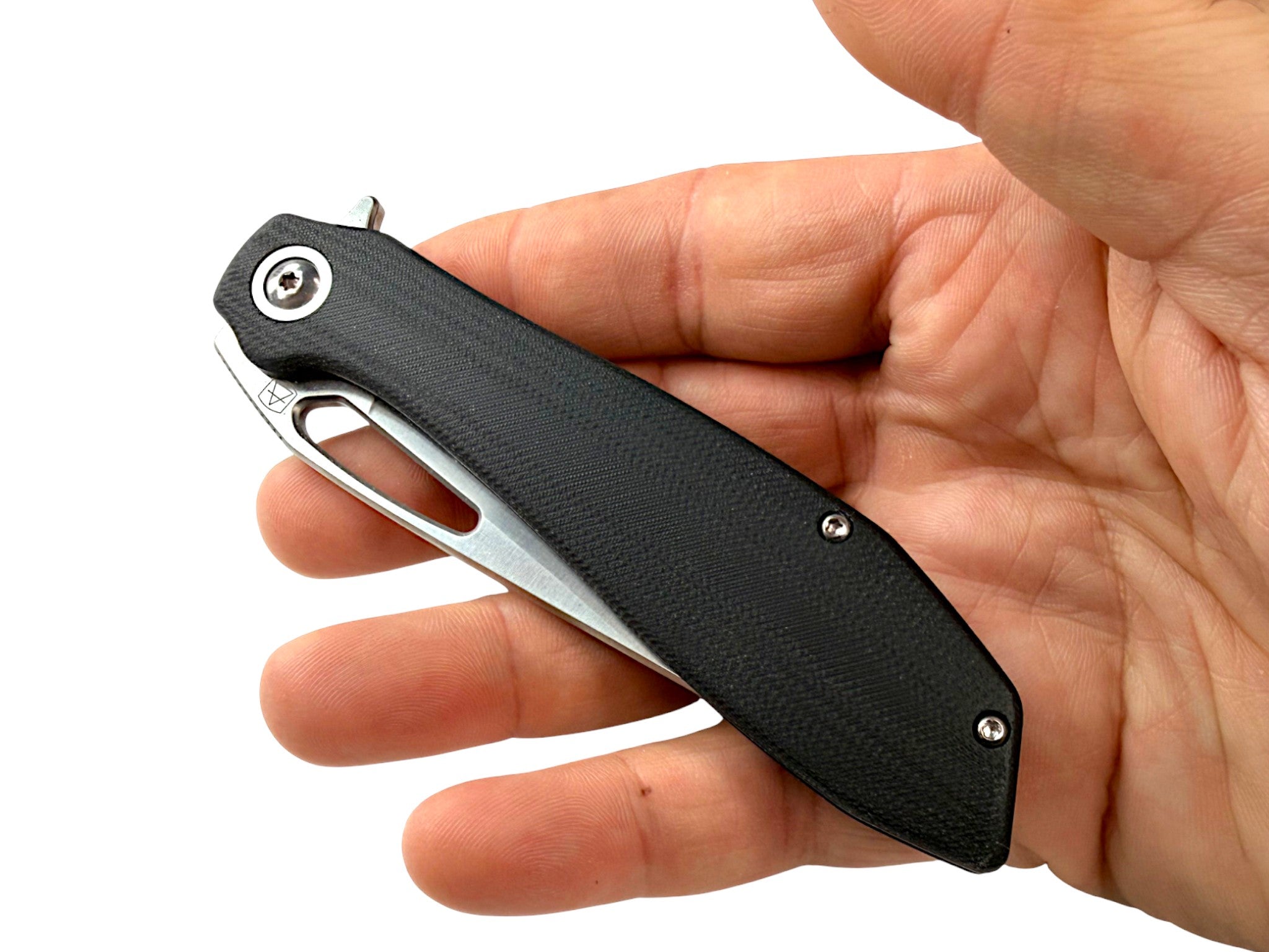 CountyComm Exclusive BXTR folding knife with black G10 handle and semi-polished steel blade held in hand.