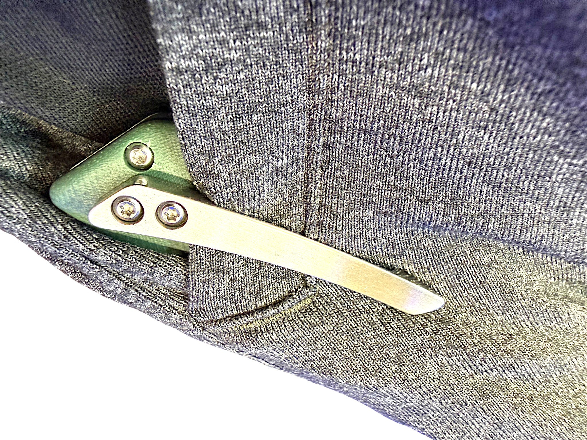 CountyComm BXTR folding knife with a semi-polished steel blade and green G10 handle, clipped to grey fabric.