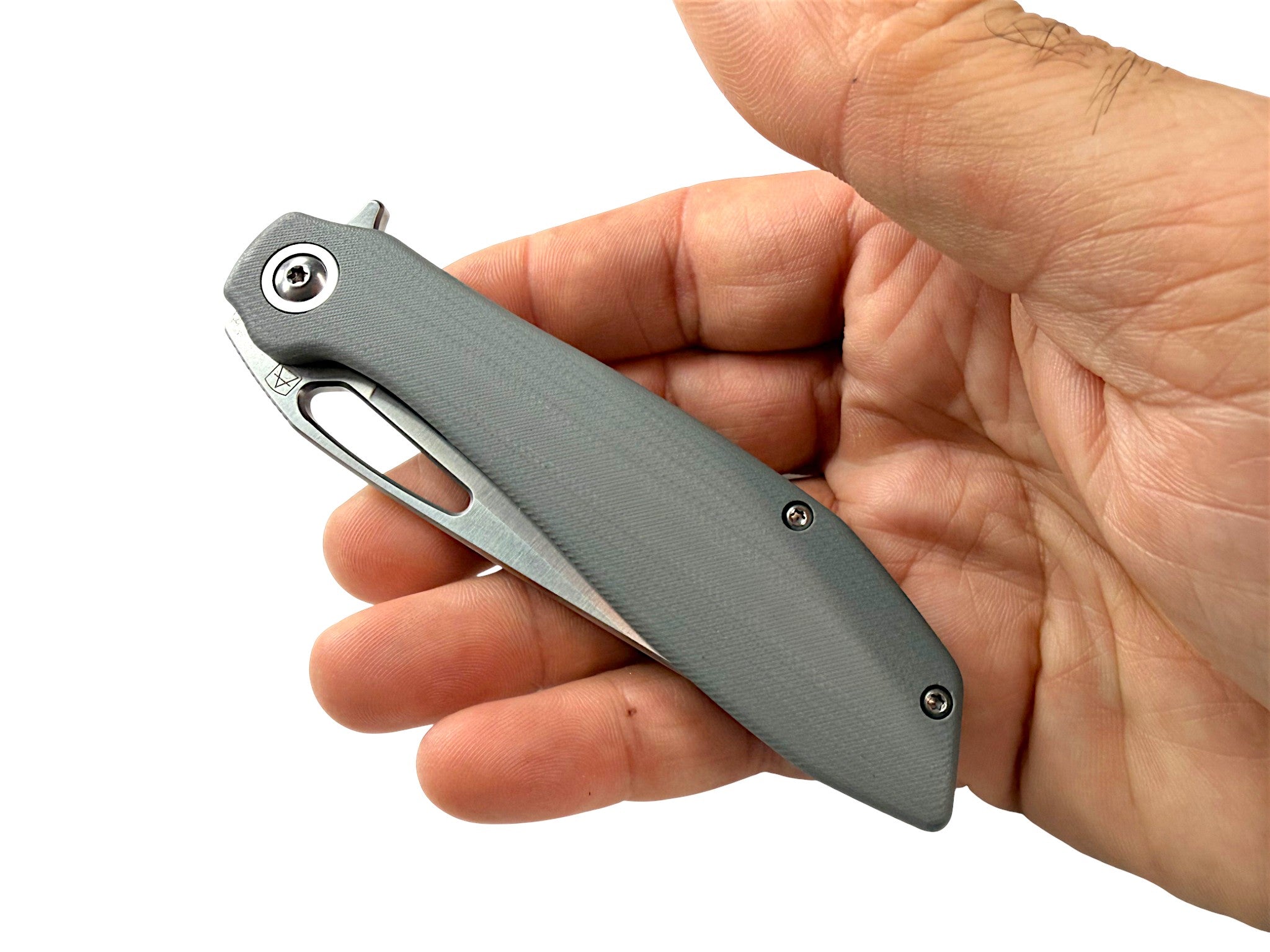 CountyComm Exclusive BXTR folding knife with a grey G10 handle and semi-polished steel blade held in a hand.