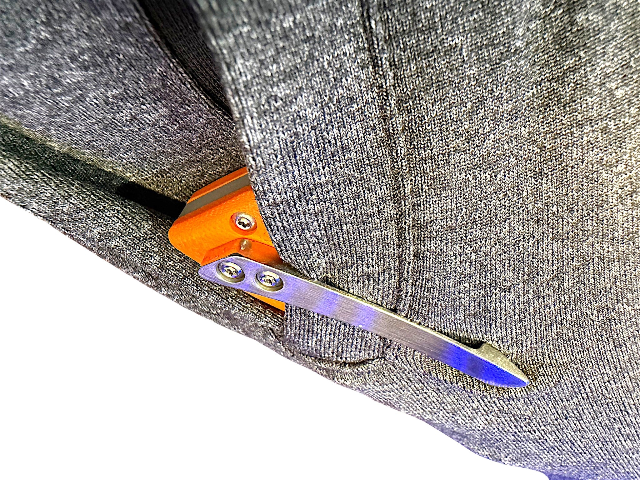 CountyComm Exclusive BXTR folding knife with orange handle and semi-polished steel blade clipped to grey fabric.