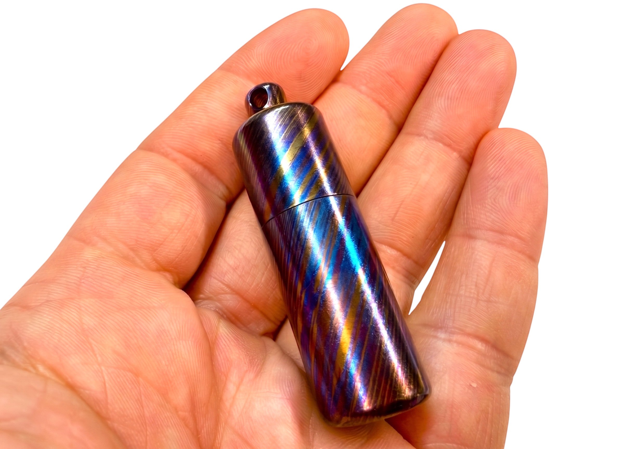 CountyComm Timascus Titanium XL Lighter, a limited edition collectible with a unique iridescent striped pattern and a removable brass insert.