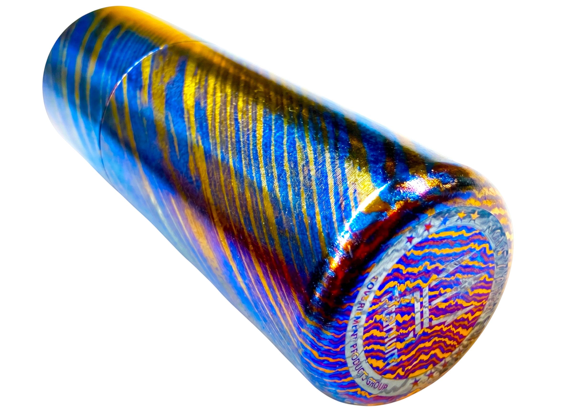 CountyComm Timascus Titanium XL Lighter with blue, gold, and red swirling patterns. Features a detailed etched bottom.